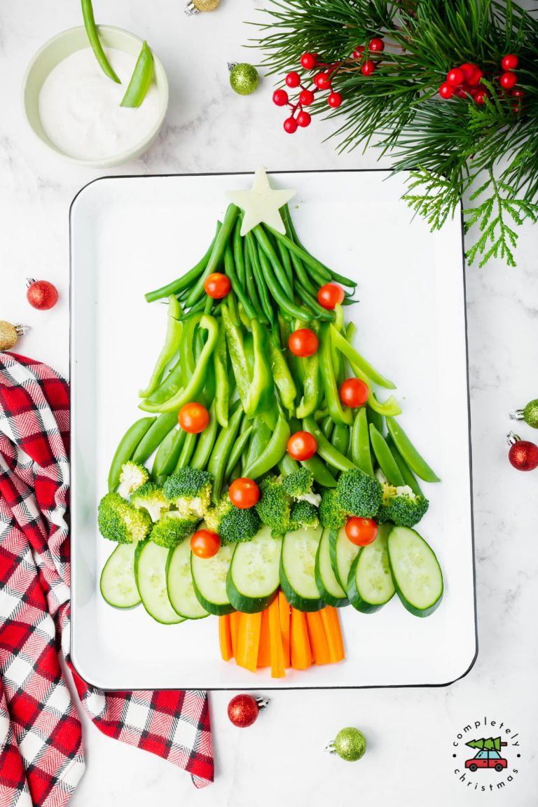 Vegetable platter in the shape of a Christmas tree on a white baking sheet.