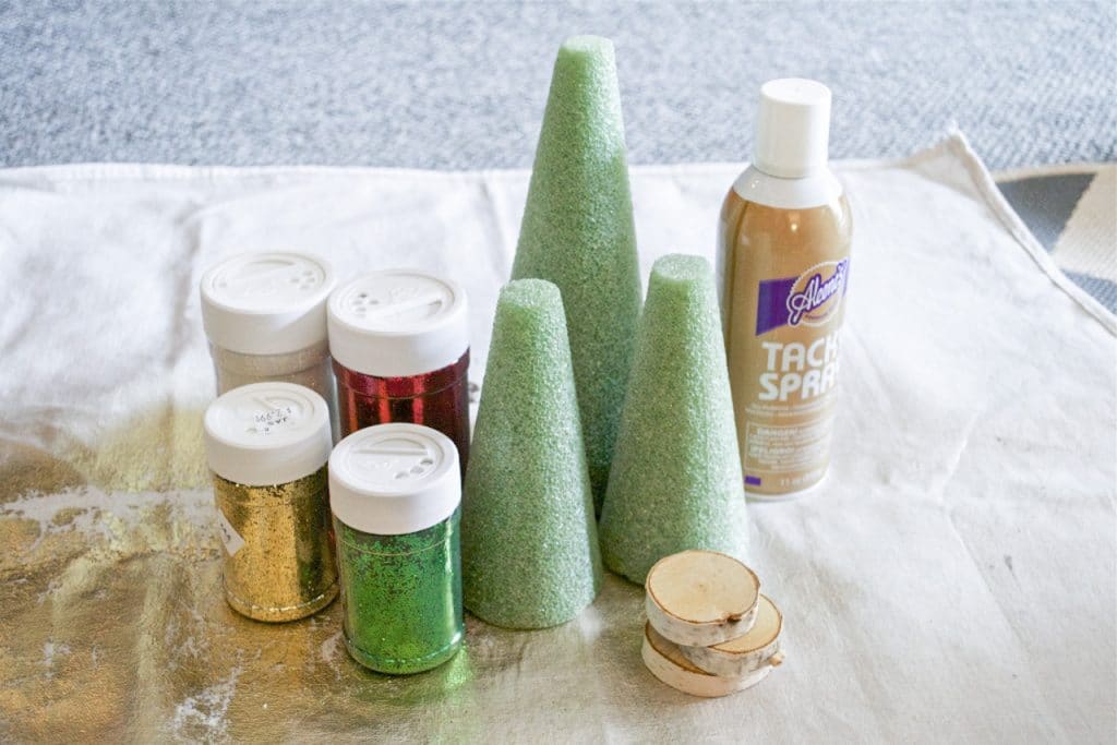 Supplies for making glitter christmas tree cones.