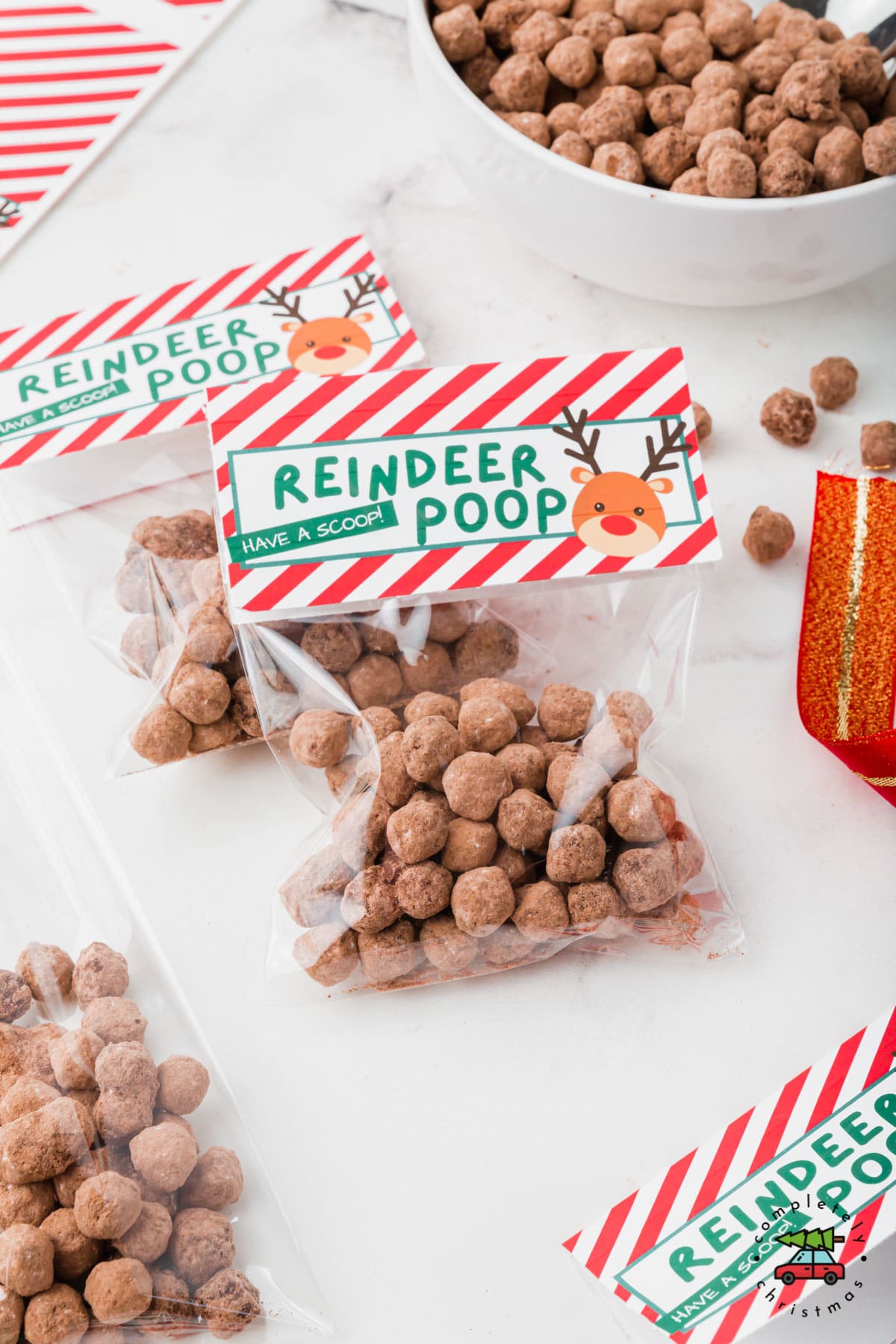 Two bags of reindeer poop dessert with holiday bag topper.