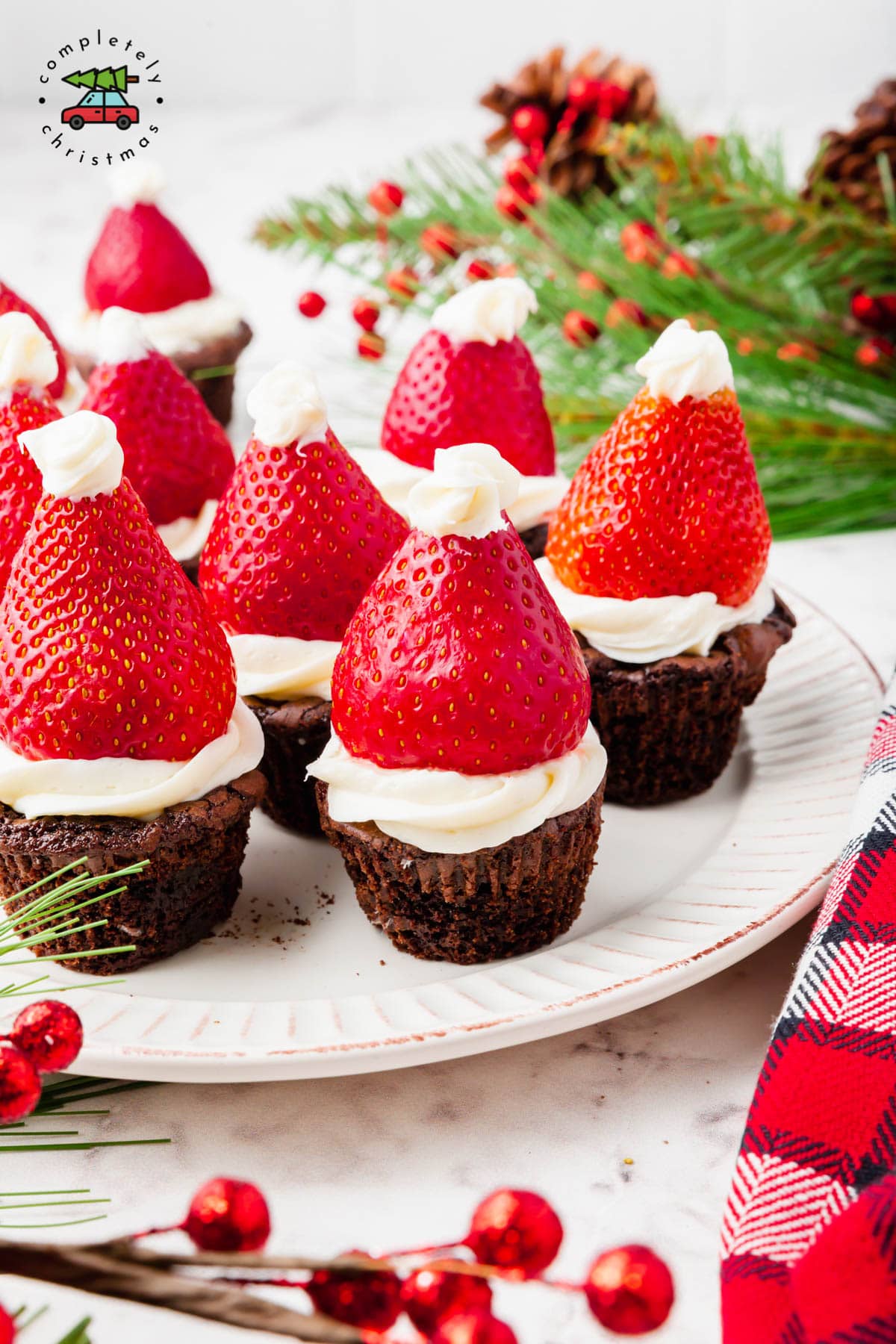 A plate of strawberry santa hat brownie bites.