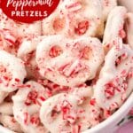 A close up of white chocolate pretzels with crushed candy canes in a bowl.