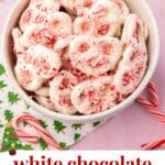 A bowl of white chocolate covered pretzels topped with crushed up candy canes.
