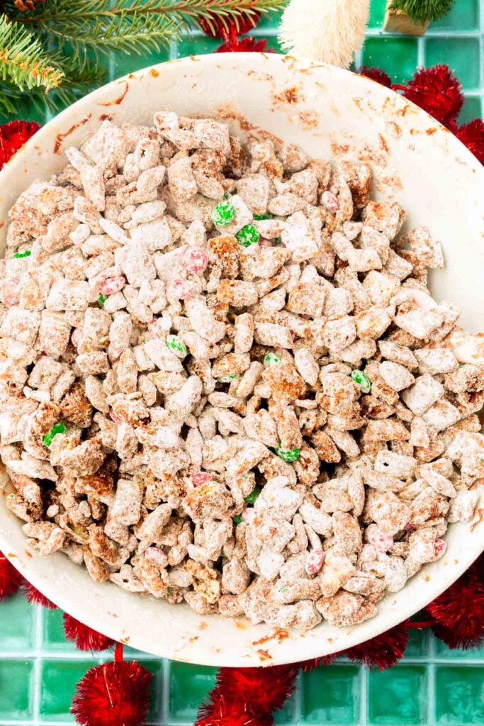 A large bowl of rice chex cereal covered with melted chocolate and powdred sugar.