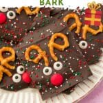 A closeup of pieces of chocolate reindeer bark on a dessert plate with a text overlay.