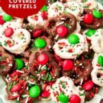 A plate of Christmas chocolate pretzels dipped in either white chocolate or semi-sweet chocolate and topped with Christmas sprinkles and green and red M&Ms.
