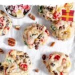 Fruitcake cookies spread out on parchment paper.