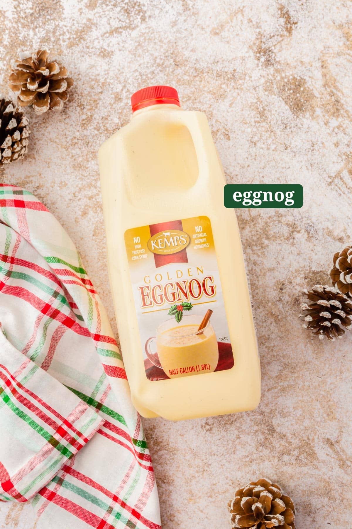 A half gallon jug of eggnog on a table with a text overlay over it.