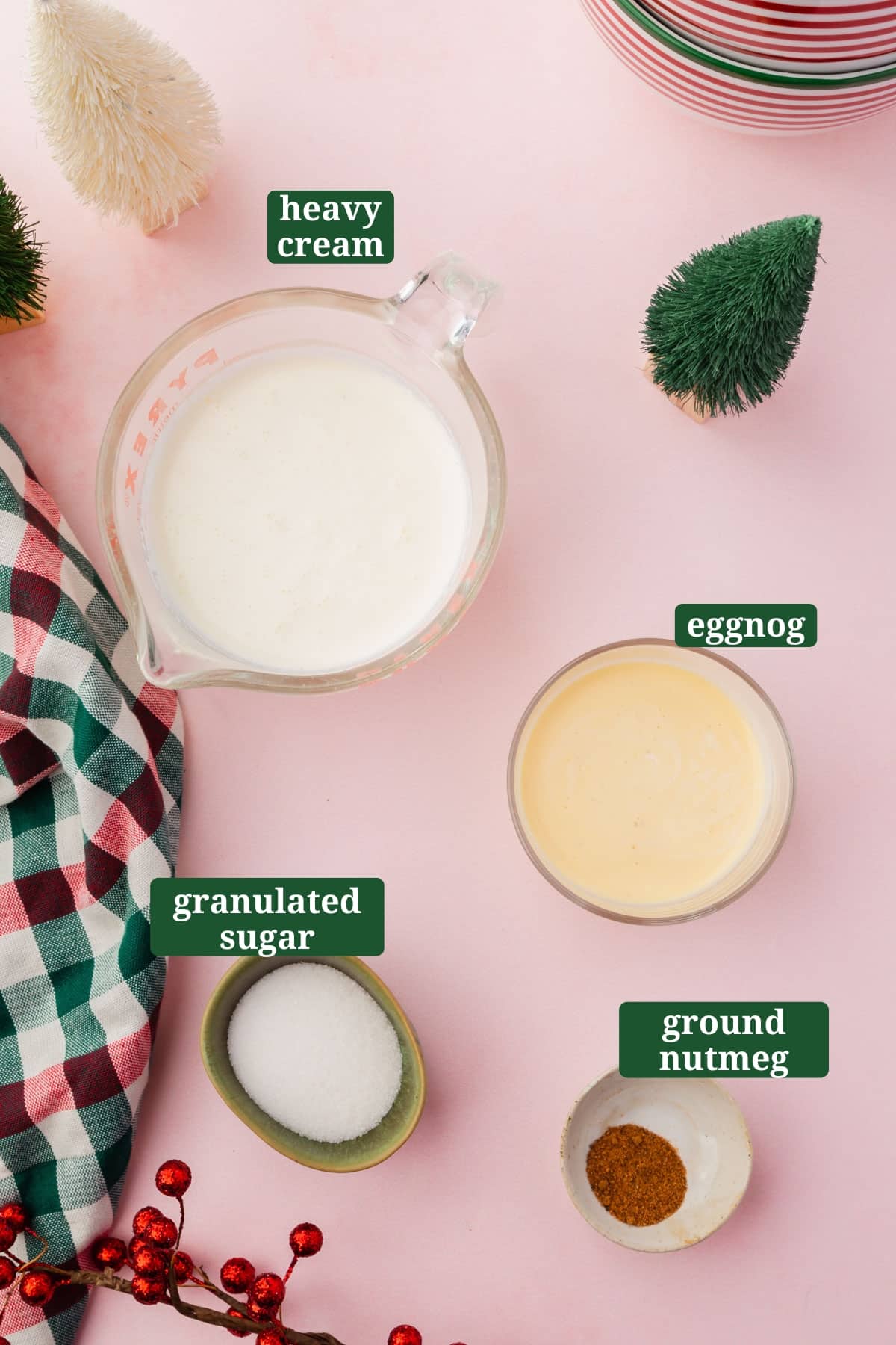 Ingredients in small bowls to make eggnog whipped cream, including eggnog, heavy cream, granulated sugar, and ground nutmeg with text overlays over each ingredient.
