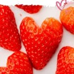 Heart shaped strawberries on a small plate.
