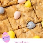 A closeup of sliced Easter blondies with mini chocolate eggs.