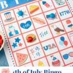 A close up of a 4th of July bingo card with red and blue M&Ms covering a few squares.