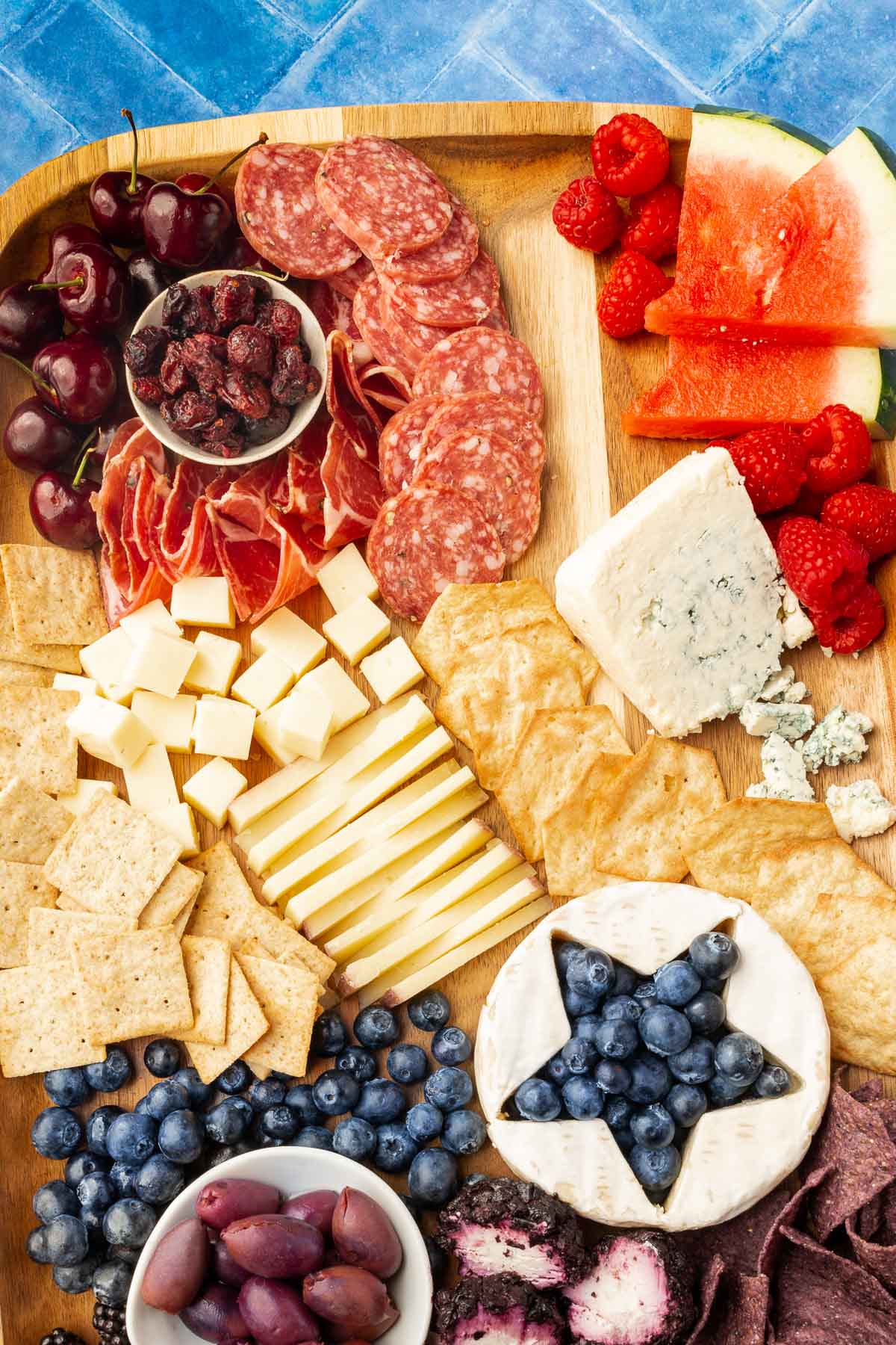 A close up of a 4th of july charcuterie board with red, white and blue ingredients.