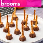 Pinterest image showing peanut butter cup pretzel witch brooms on a white tray with pink text overlay reading “Pretzel Witches’ Brooms.”