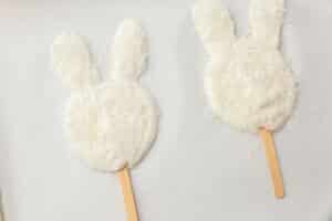 Bunny-shaped yogurt pops coated in shredded coconut to create a fluffy bunny texture.